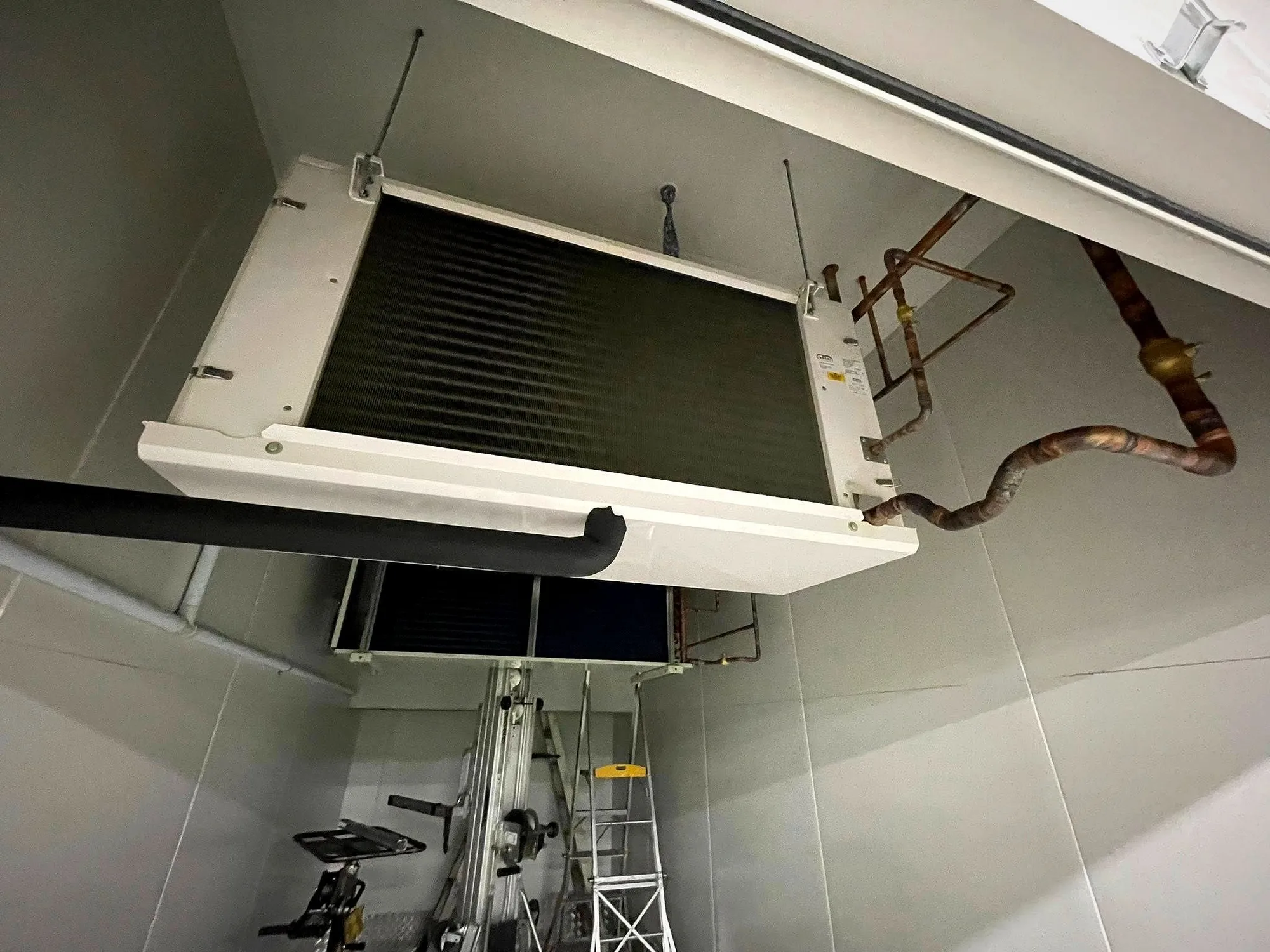 A new indoor air conditioning unit and copper pipework being installed by Classic Air and Mechanical Services